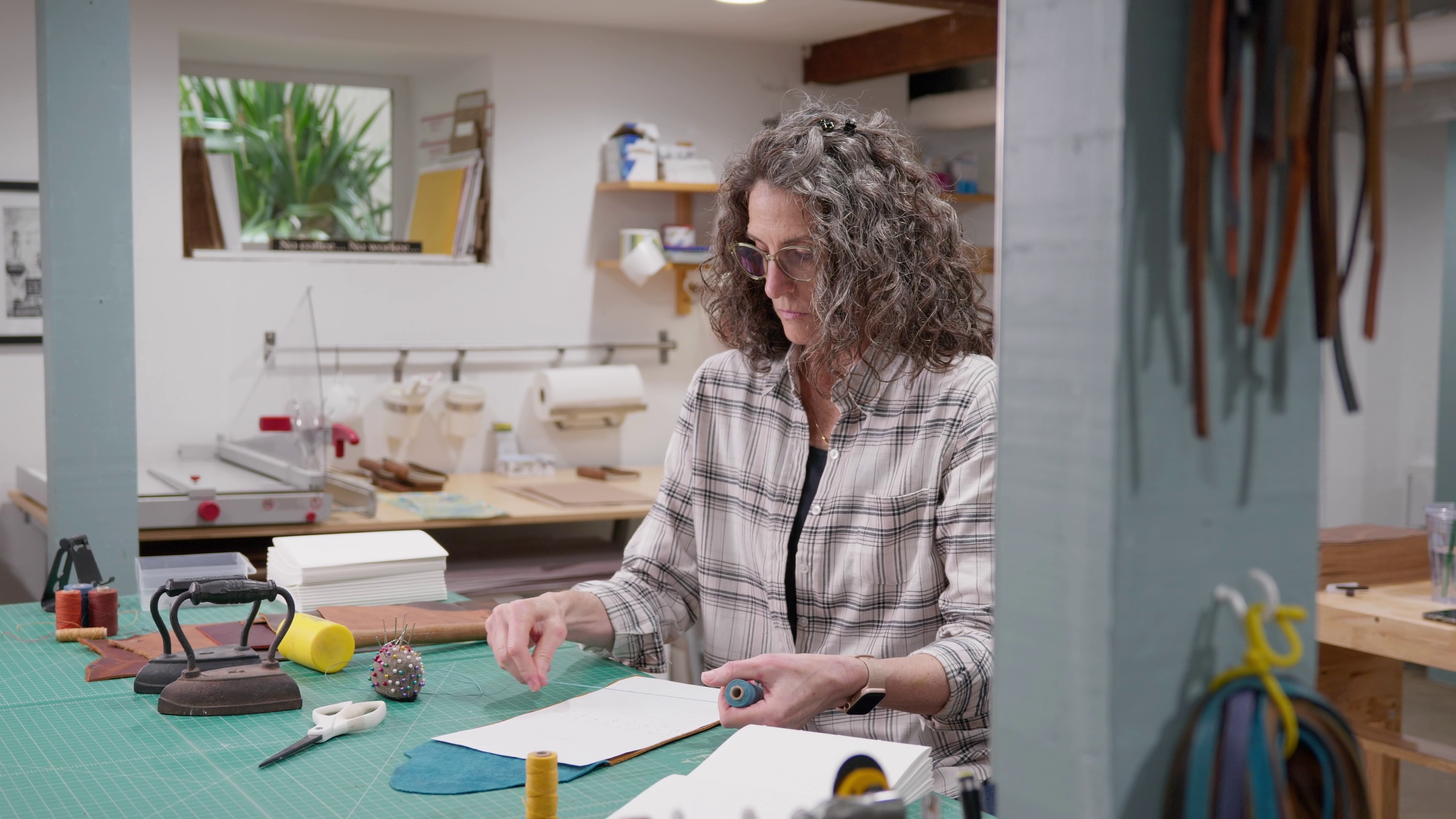 Load video: Kris Stewart in her studio making a leather journal step by step